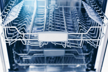 Home appliance dishwashing machine in kitchen interior, no people
