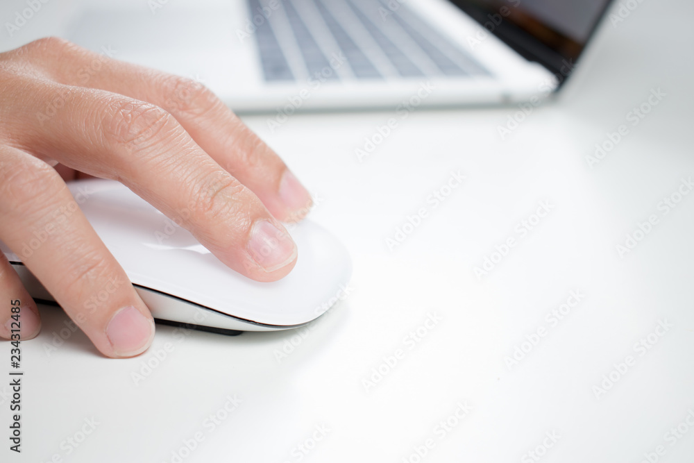 Poster close up of a businessman holding a computer mouse while working.