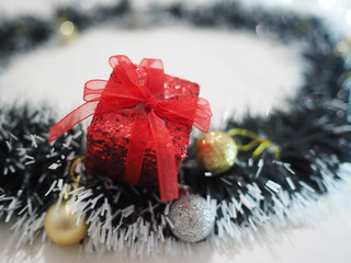 Fototapeta na wymiar Close up red gift box on christmas decoration with golden and silver ball