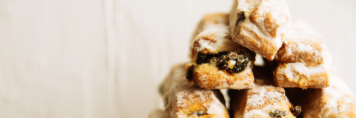 Strudel Apple and sugar powder. Biscuit from the puffed Test on the Gray Background. Dessert with Fruits.Copy space for Text. selective focus.