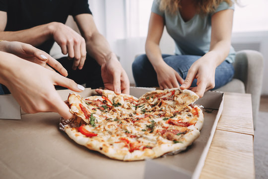 Friendship, Conversation, Food Delivery, Togetherness, Leisure, Party. Young Cheerful People Talking And Having Fun Together In Living Room, Students Chatting Sharing Pizza At Table, Close Up