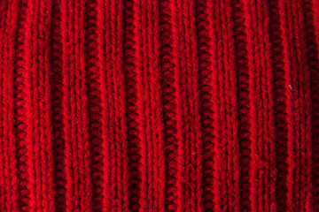 texture of knitted stripes of red yarn