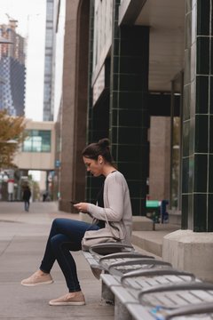 Woman using mobile phone in the city
