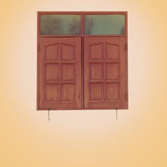 A regular wooden framed window with shutters on an isolated plastered wall with color filter