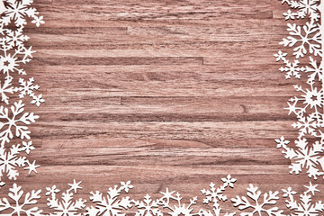 snowflakes framing wood background