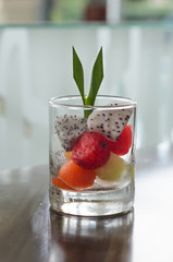 Fruit salad with melon, papaya and watermelon balls in glass