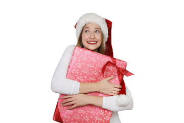 Jübsche Frau mit Weihnachtsmütze lacht und hält ein Weihnachtsgeschenk in den Armen 