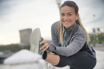 Woman smiling whilst strething before a run