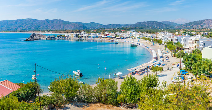 Haraki beach with apartment houses and holiday makers enjoying their time (Rhodes, Greece)