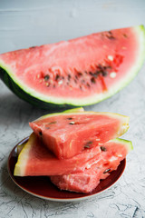 Slices of fresh ripe watermelon on a light background