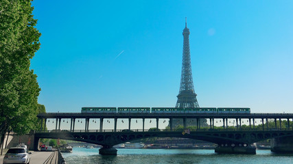 Paris, France - circa May, 2017: Traffic in Paris with Eiffel Tower and Bir Hakeim bridge over...