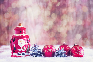 Lantern and Christmas ornaments against bokeh background