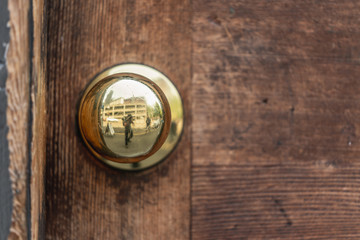 Fototapeta premium Rustic Antique Bronze Door knob wood reflection