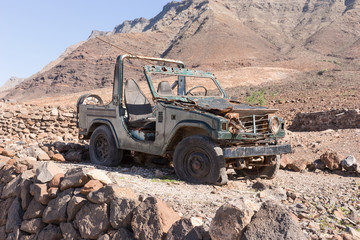 Old rusty jeep stands abandoned in the mountains