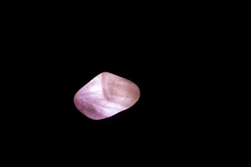 close-up on mineral, pink quartz, black background