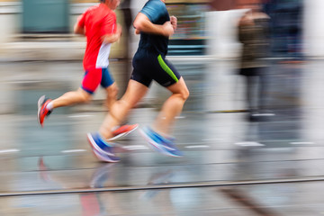 running men in the rainy city