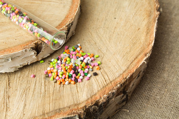 Colored plastic granules  on the background birch.The concept of environmental friendliness of ...