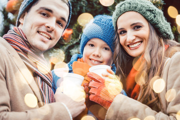 Familie mit Essen und Trinken auf dem Weihnachtsmarkt