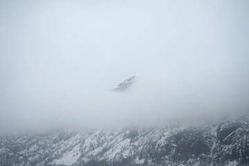 Pick of mountain covered by fog.