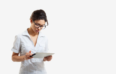 Portrait of a young beautiful woman in glasses with a tablet