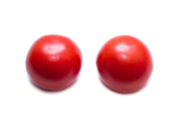 Two juicy red tomatoes isolated on white background. View from above