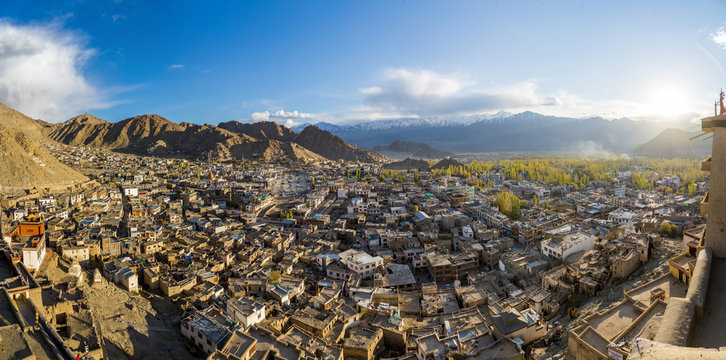 Panorama view of Leh city in autumn and mountain in background. The capital of Ladakh, Northern India. Cityscape with sunlight view from Leh palace