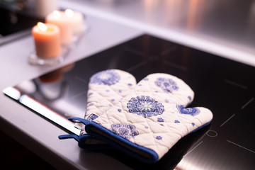 Kitchen gloves are on the stove.