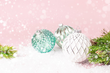Fototapeta na wymiar Vintage Christmas New Year balls in the snow and pine branches on pink background Flat Lay copy space. Holiday Baubles, beautiful Decoration Festive decor, celebration Xmas holiday greeting card