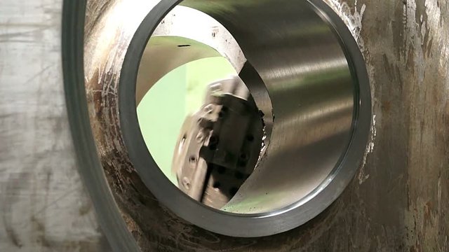 huge lathe closeup, large spindle lathe is rotating at an industrial plant. Shooting is made at a plant producing power steam turbines,Turning lathe in action,Industrial CNC drill machine,