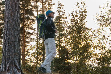 a man in the forest... man backpack.
