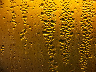 Drops of water on a cold glass.