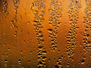 Drops of water on a cold glass.