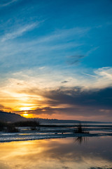 The sea and the beautiful expanse of blue sky with clouds and sunlight at sunset. Russia Azov sea.