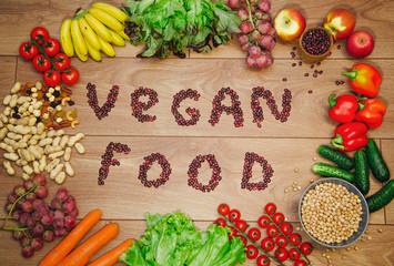 Go vegan concept green organic vegetables & bean on wood background.