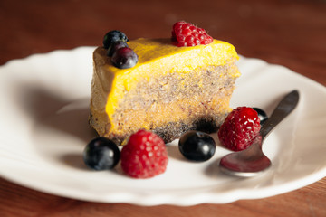Slice of raw vegan cake with berry fruit.