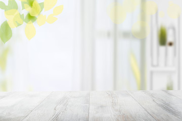 Table top and blur interior background. Rustic wooden bright table top and blurred kitchen interior...