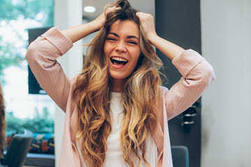 Woman with long hair sitting in a hairdresser