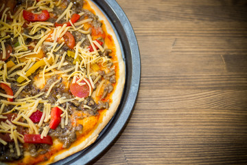 homemade pizza with forest mushrooms, peppers and tomatoes