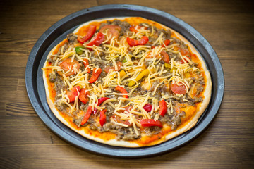 homemade pizza with forest mushrooms, peppers and tomatoes