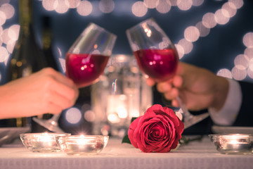 Romantic date night. Man and woman toasting wine in a restaurant setting.