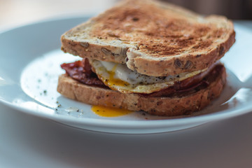 Homemade Breakfast Egg Sandwich with Cheese and bacon on Toast