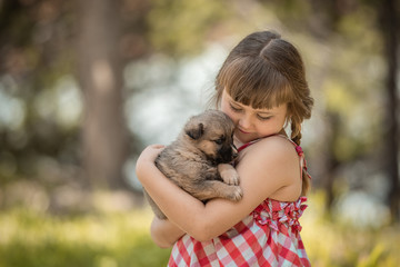 Cute little girl with a little puppy.