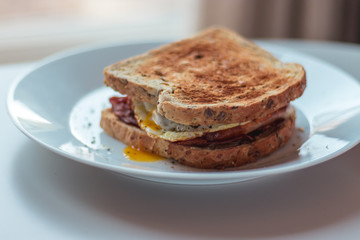 Homemade Breakfast Egg Sandwich with Cheese and bacon on Toast