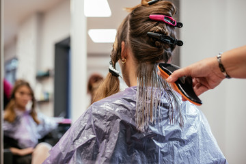 Hairdresser dyeing a woman's hair