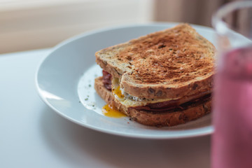 Homemade Breakfast Egg Sandwich with Cheese and bacon on Toast