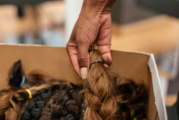 Box of braided hair for cancer donation