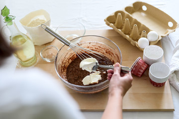 Cooking Christmas chocolate muffins. Mixing ingredients for brownies, cupcakes, pancakes. Woman hands preparing