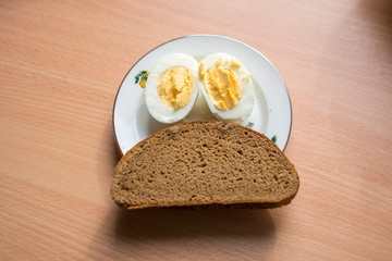 Rye bread and boiled egg on the plate
