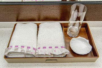 white terry towels with a pink ribbon. soft gentle towels for the bathroom. cream towel set for the...