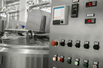 electronic control panel and tank at a milk factory. equipment at the dairy plant